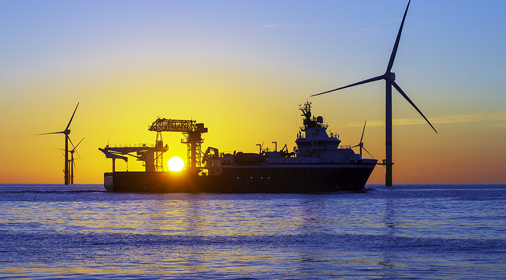 Offshore Wind Farm And Vessel At Sunset Shutterstock