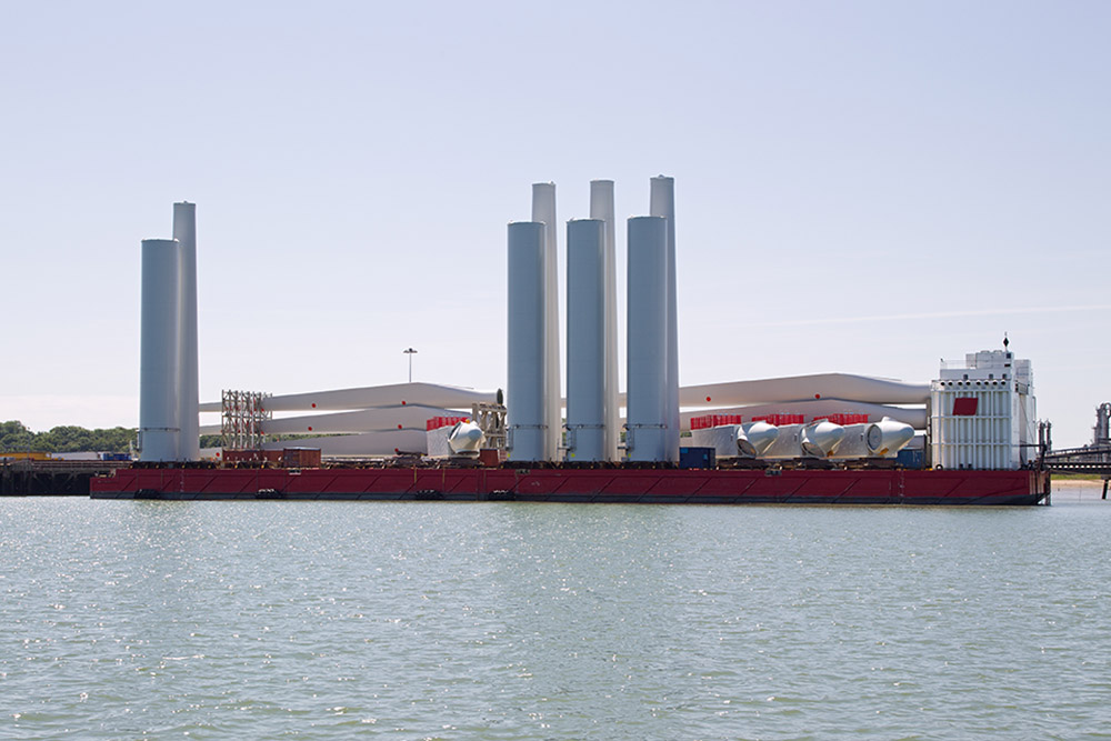 A Semi Submersible Barge Loaded With Wind Turbines In Harbor In The UK